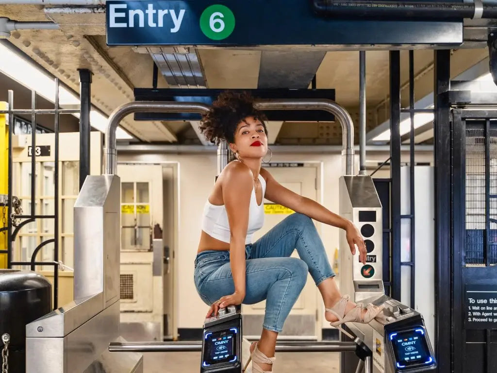 Danielle Alonzo seated at the entrance to the 6 train