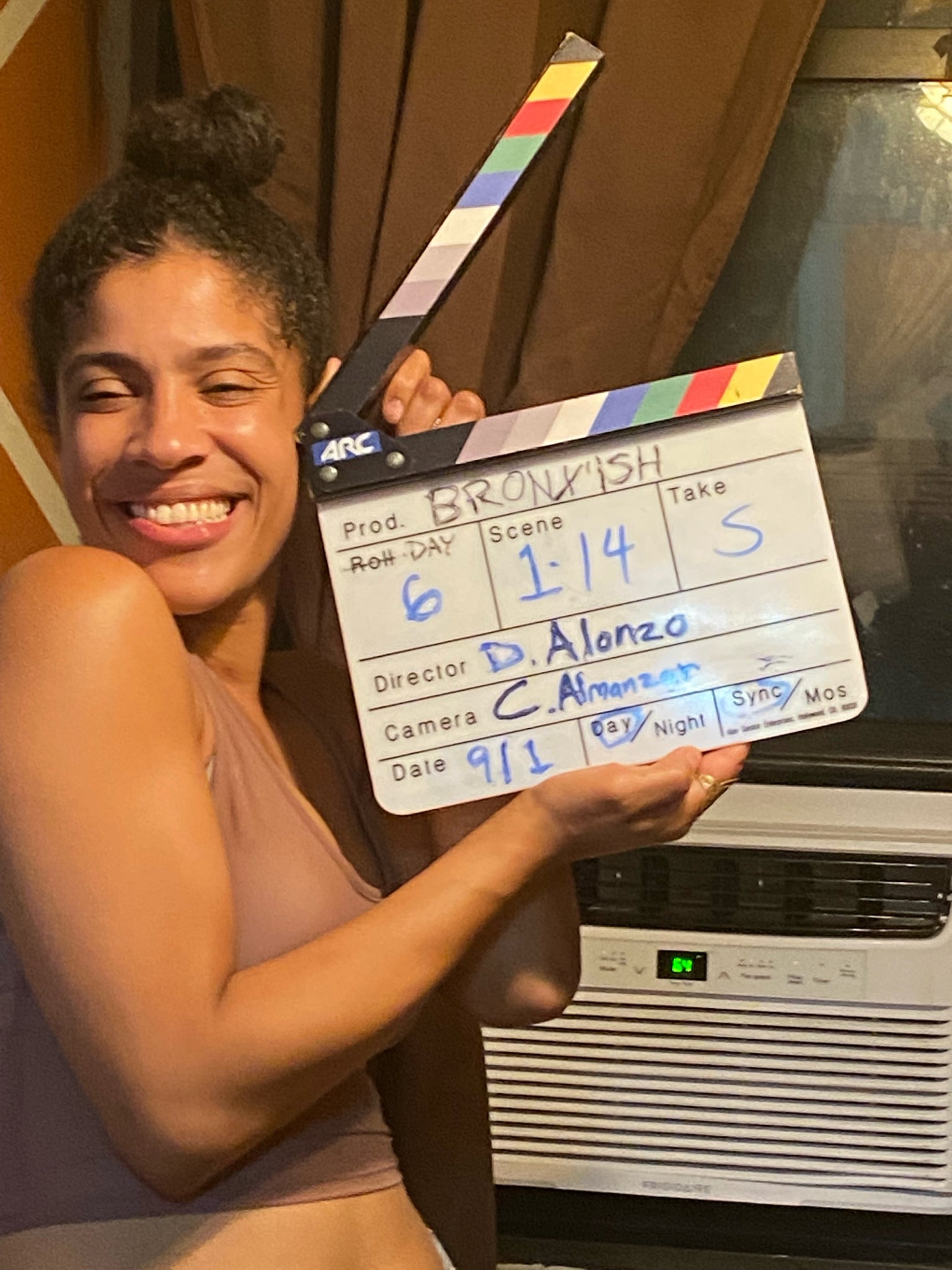 Danielle Alonzo smiling with a Bronx &rsquo;ish clapperboard on set