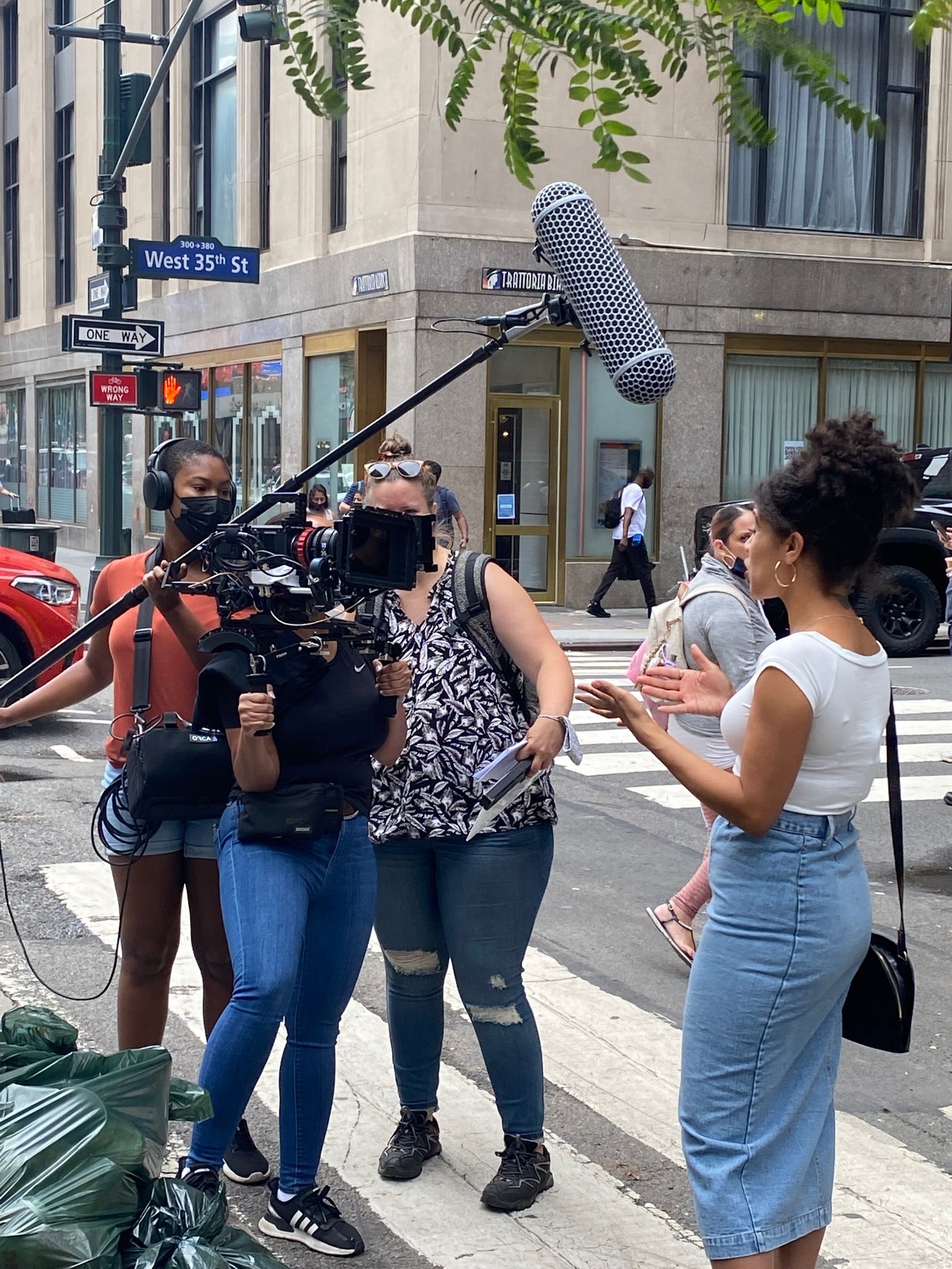 Danielle Alonzo directing a Bronx &rsquo;ish scene on a New York street with a boom mic overhead